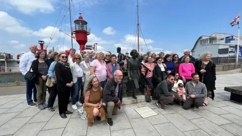 Stuart Woodward/BBC  Kindertransport relatives in Harwich, gathered around the Kindertransport statue