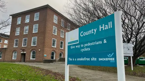 A sign for County Hall offices in front of the Devon County Council's headquarters on Topsham Road in Exeter