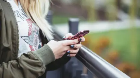 BBC Person using phone