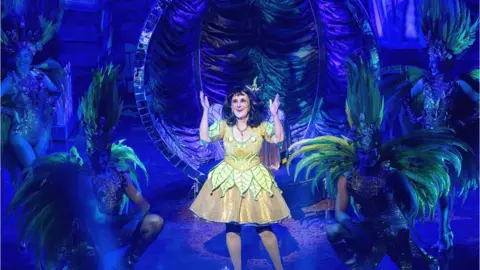 Tim Dickeson Lesley Joseph on stage as "the spirit of the beans"