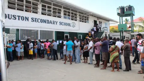 Reuters People in Georgetown, Guyana, wait in a queue to cast their vote