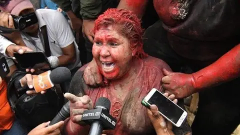 EPA Patricia Arce speaks to the media after being attacked by a crowd that sprayed her with reddish paint and cut her hair in Vinto, Bolivia, 06 November 2019