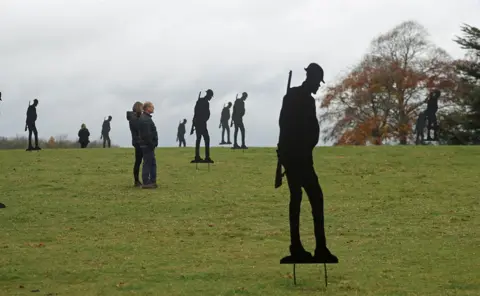 Steve Parsons / PA Wire People observe a two minute silence amongst two hundred silhouettes of soldiers