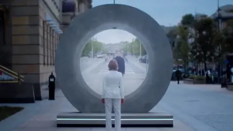 A woman standing in front of the PORTAL