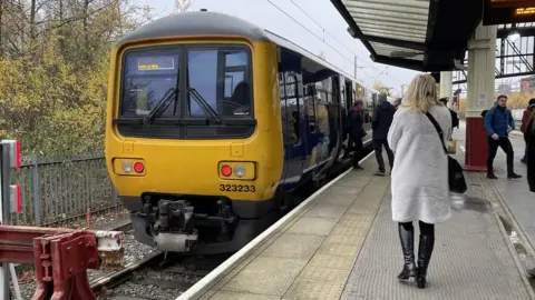 Northern train at platform with passengers