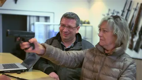 Ann Barnes is shown weapons for sale in France