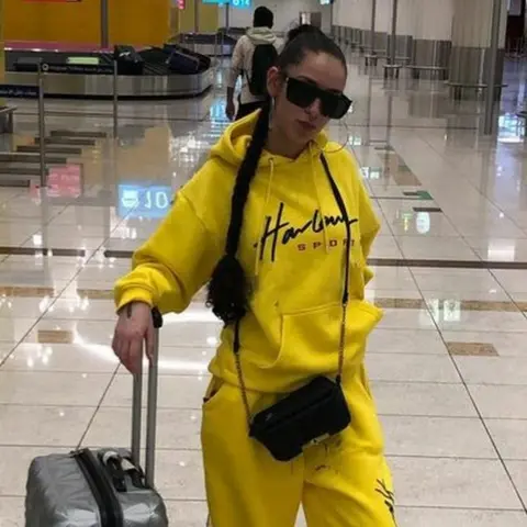 Family handout Picture of Sofia Duarte in a yellow tracksuit.