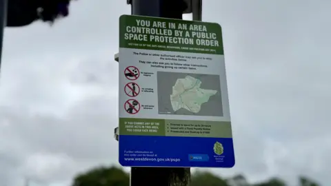 PSPO sign in Tavistock. The sign says: 'You are in an area controlled by a public space protection order'.
