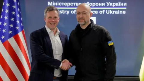 Reuters US Army Secretary Dan Driscoll (left) shakes hands with Ukrainian Defence Minister Denys Shmyhal in Kyiv, Ukraine. Photo: 19 November 2025