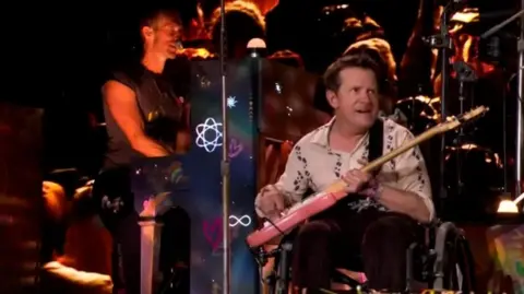 Michael J Fox joins Coldplay on stage