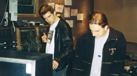 Nick Brine Nick with Ian Brown of the Stone Roses in Rockfield Studios. They are standing in the studio with music recording equipment around them.