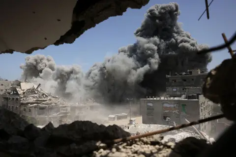 AFP via Getty Images Smoke and debris rise following an Israeli strike on a house west of Jabalia, in the northern Gaza Strip, on June 1, 2025.