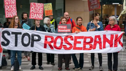 PA Media Demonstrators with a Stop Rosebank banner
