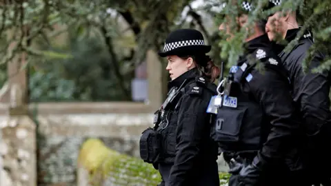 Police officers stand guard outside the Sandringham Estate on 20 February 2026