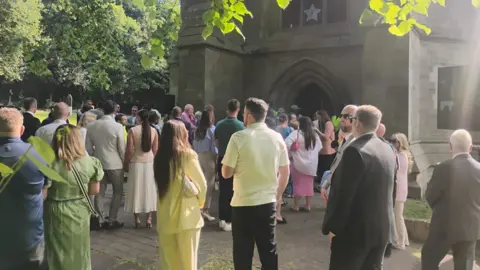 Crowds stitchery  extracurricular  St Marks Church successful  Worsley connected  a sunny day.