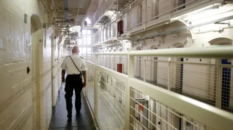 PA A prison officer walks through HMP Barlinnie in Glasgow