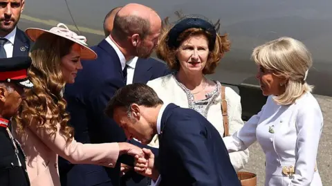 Britain's Prince William, Prince of Wales and Britain's Catherine, Princess of Wales greet France's President Emmanuel Macron and his wife Brigitte Macron, upon arrival at RAF Northolt, west of London