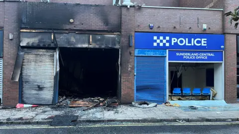 BBC A police office damaged following disorder in Sunderland