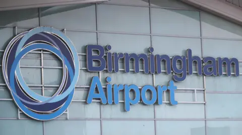 PA Media The outside of Birmingham Airport. The word Birmingham in in dark blue whereas the word airport is in a light blue. There is a circular dark and light blue logo next to the the words.