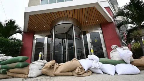 Getty Images Sandbags placed outside the front of a hotel in preparation for the arrival of Hurricane Melissa 