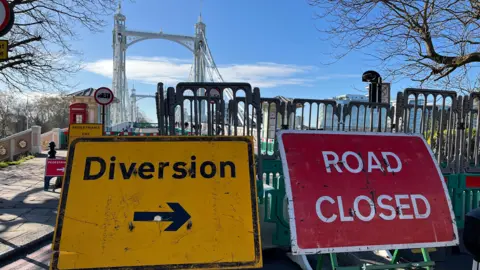 A road closed sign blocks the road to Albert Bridge