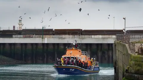 PA Media An RNLI boat brings people ashore at Dover