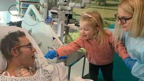 Craig Mackinlay  Mr Mackinlay with his family in hospital