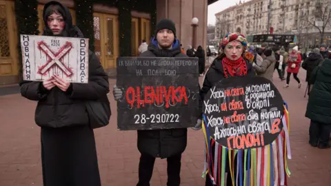 BBC People are seen protesting the return of prisoners of war