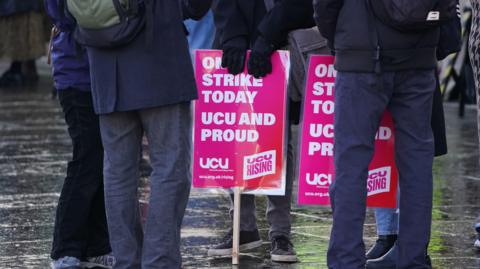 People holding UCU strike placards outside the Scottish parliament in 2023