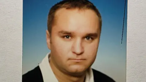 Handout Ladislav Csaladi, a man with short, fair hair, looks to the camera. He is wearing a black rugby-type top with a white collar. 