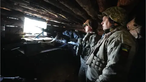 BBC/Lee Durant Officers with Ukraine's 77 Brigade prepare to direct artillery fire to support their infantry