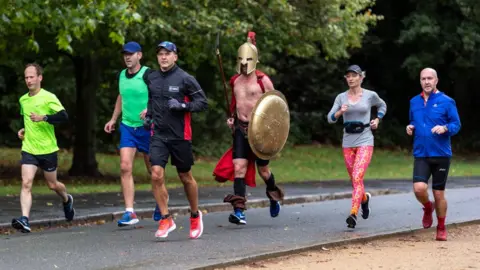 NurPhoto Runners take part in the Virtual London Marathon in Dulwich Park, south London on 4 October