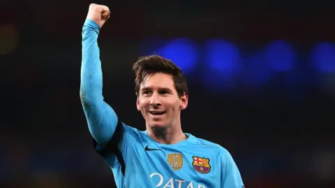 PA Lionel Messi raises his fist in the air in celebration