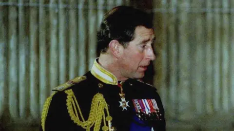 Reuters Then Prince Charles, a middle aged man wearing a military uniform adorned with medals.
