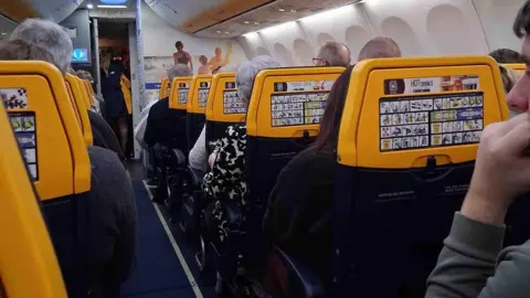 Marie Casey Interior of Ryan Air plane. Blue and yellow decor.