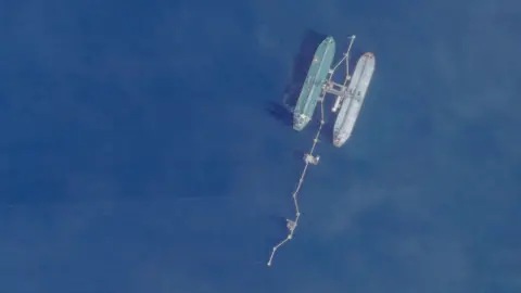 Planet Labs via Reuters A satellite image shows from above two vessels, the one on the right being the Skipper, at sea off Port Jose in Venezuela on 18 November.