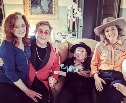 Brandi Carlile / Instagram Mitchell welcomed other musicians into her home during her recovery, including (L-R) Bonnie Raitt, Sir Elton John and Brandi Carlile