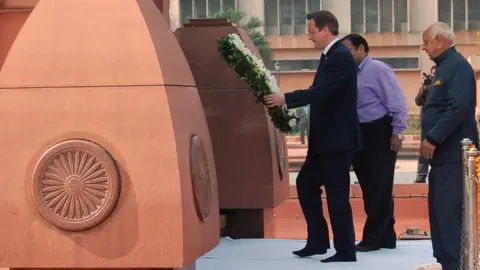 Getty Images British Prime Minister David Cameron lays a wreath in tribute to the Jallianwala Bagh martyrs at the Jallianwala Bagh memorial in Amritsar on February 20, 2013. British Prime Minister David Cameron visited the site of a colonial-era massacre in India on Wednesday, describing the episode as "deeply shameful" while stopping short of a public apology.