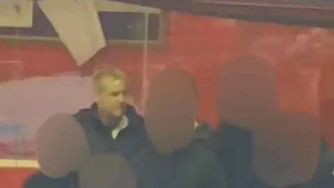 A photograph released of police of a man they would like to speak to in connection with the incident. There are five more faces around him that have been blurred to avoid identifying them. 