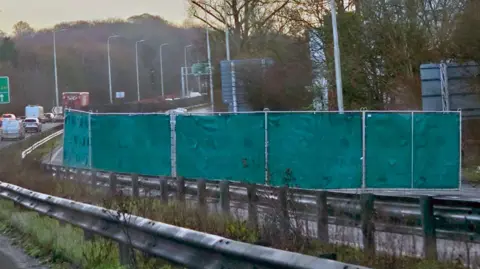 Fences with covers covering a section of a major road.