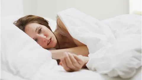 Getty Images Woman in bed with flu