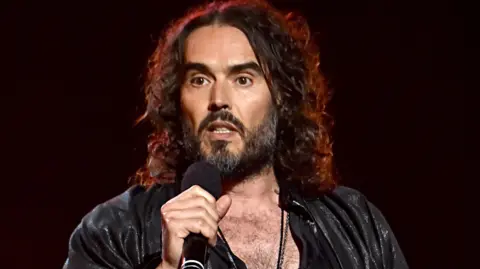 Russell Brand performing in 2022