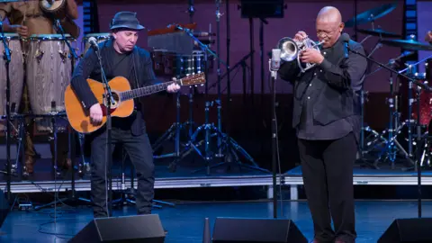 Getty Images Hugh Masekela with Paul Simon in 2014