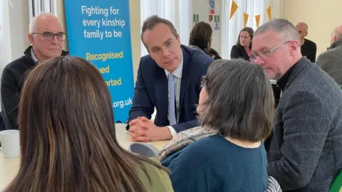 Sam Read/BBC David Johnston speaking to kinship carers in Luton