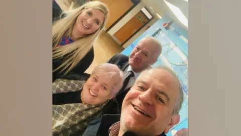 A selfie of Broxtowe councillors standing in a leisure centre with Rebecca Adlington.