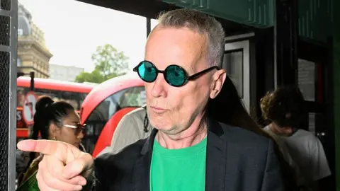 Getty Images Frank Skinner in green glasses and a green T-shirt.