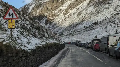 Cars parked along the road at Pen y Pass in Eryri National Park