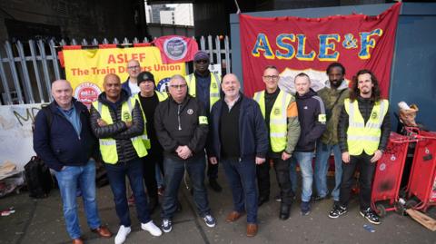 Aslef members stand on a picket line outside London Waterloo station, with General Secretary Mick Whealan in the middle