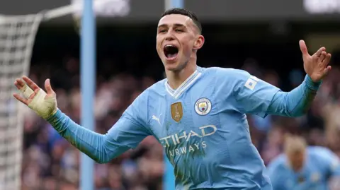 Manchester City's Phil Foden celebrates scoring against Manchester United