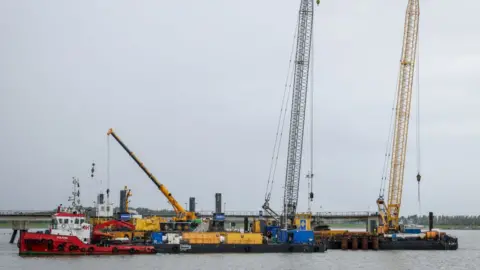 Getty Images A tug boat and cranes are seen at the construction site of the Uniper Liquefied Natural Gas (LNG) terminal at the Jade Bight in Wilhelmshaven on the North Sea coast, north-western Germany, on September 29, 2022